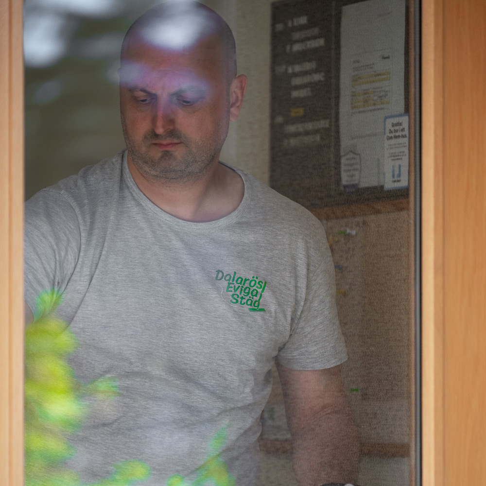 En bild på en anställd som putsar fönster